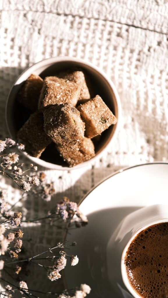 coffee and brown sugar cubes on textured background